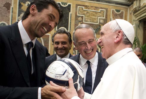 Pope Francis receives soccer ball as gift from Italy's goalkeeper Buffon during private audience at Vatican