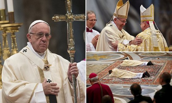 New bishops Miguel Angel Ayuso Guixot from Spain (C) and Peter Bryan Wells from the U.S. lie in front of the altar during their ordination ceremony in Saint Peter's Basilica at the Vatican March 19, 2016. REUTERS/Tony Gentile