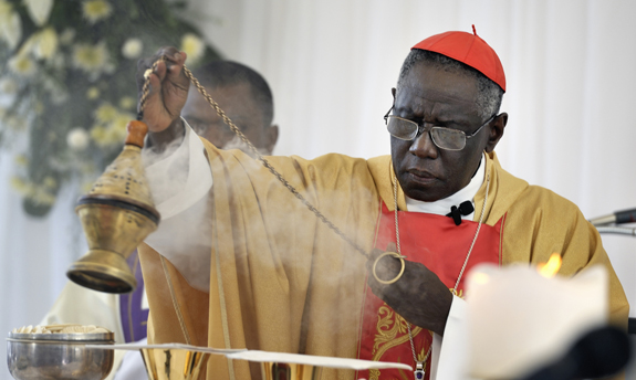 Cardinal Robert Sarah, president of the Pontifical Council Cor Unum, swings a censer as he celebrates Mass in Port-au-Prince marking the one-year anniversary of the Jan. 12, 2010, earthquake that devastated Haiti. Held in the shadows of the ruins of the Cathedral of Our Lady of the Assumption, the gathering was one of many special observances held throughout the Caribbean nation. (CNS photo/Paul Jeffrey) (Jan. 12, 2011) See stories slugged HAITI- Jan. 12, 2011.