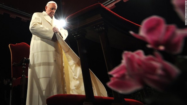 Pope Francis puts his coat on during the celebration of the Way of the Cross on Good Friday on March 29, 2013 at the Colosseum in Rome. Pope Francis presided over his first Good Friday which will culminate in a torch-lit procession at Rome's Colosseum and prayers for peace in a Middle East "torn apart by injustice and conflicts". AFP PHOTO / GABRIEL BOUYS (Photo credit should read GABRIEL BOUYS/AFP/Getty Images)