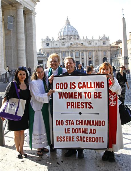 Father Roy Bougeois from Georgia (2nd R) poses with a group of Roman Catholic activist in front of the Vatican October 17, 2011. The group who think women should be ordained priests were detailed by police on Monday when they tried to demonstrate at the Vatican and deliver a petition. Witnesses said Italian police stopped the group of about 20 demonstrators and confiscated a banner reading "God is calling women to be priests". REUTERS/Max Rossi (ITALY - Tags: RELIGION)