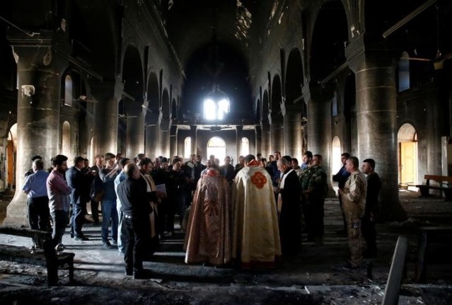 Iraqi priests hold the first Sunday mass at the Grand Immaculate Church since it was recaptured from Islamic State in Qaraqosh, near Mosul, Iraq, October 30, 2016. REUTERS/Ahmed Jadallah