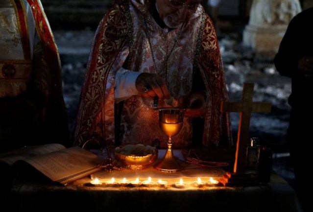 Iraqi priests hold the first Sunday mass at the Grand Immaculate Church since it was recaptured from Islamic State in Qaraqosh, near Mosul, Iraq, October 30, 2016. REUTERS/Ahmed Jadallah